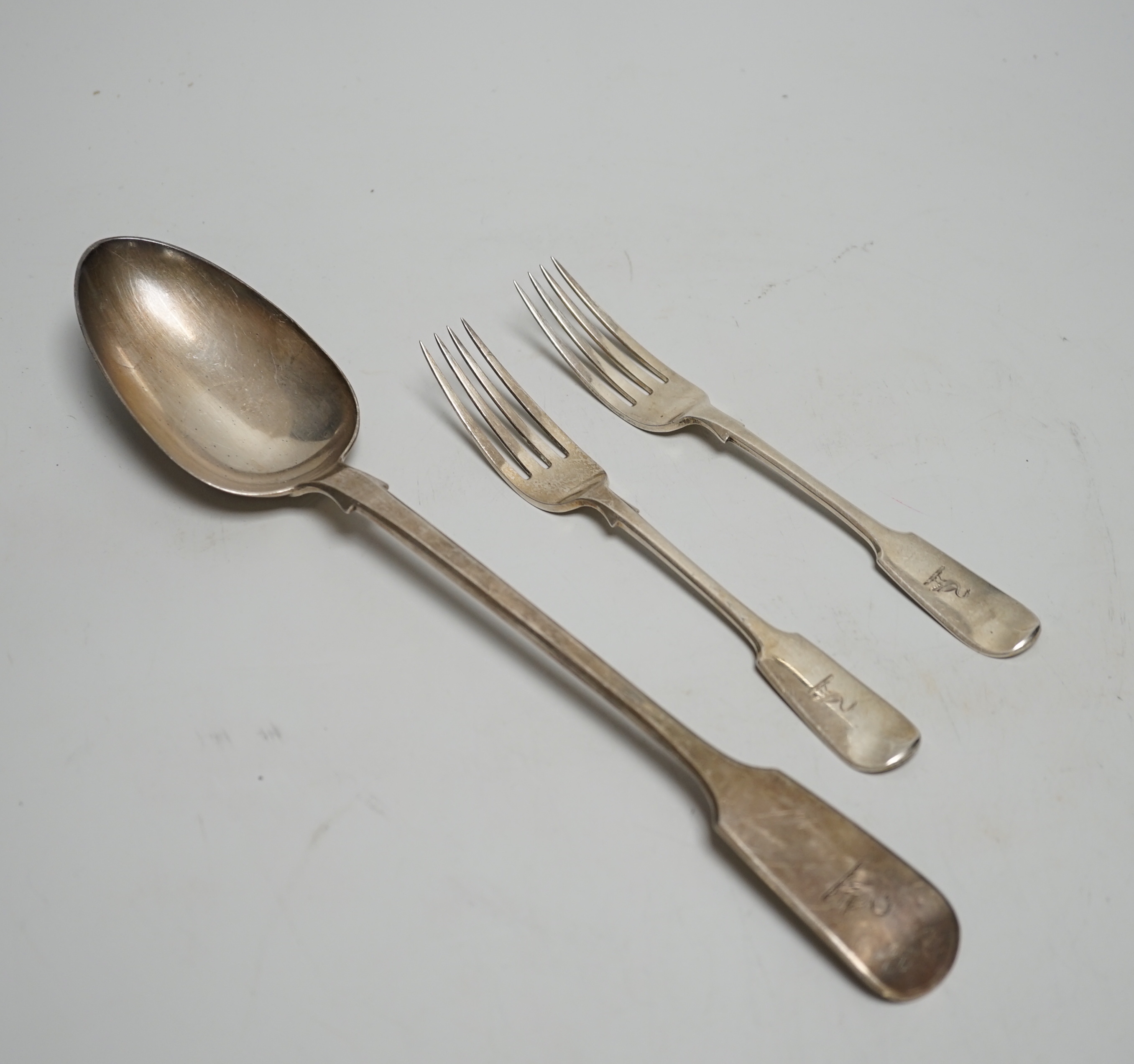 A Victorian silver fiddle pattern basting spoons, Charles Wallis, London, 1852, 30.4cm and a pair of Victorian provincial silver dessert forks, Josiah Williams & Co, Exeter, 1862, 7.6oz.